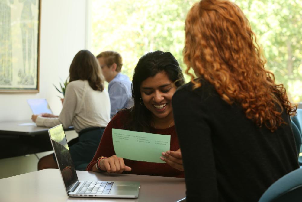 William & Mary students sitting at a desk together